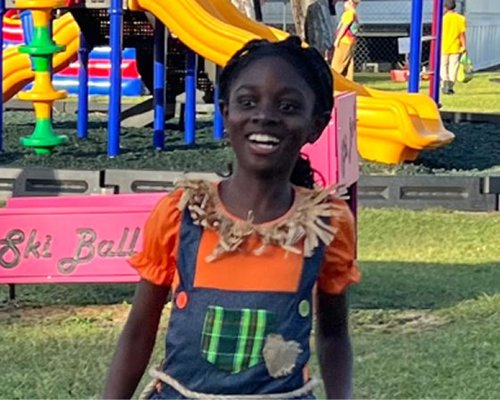 Child playing at Red Trolleys Daycare playground in Valdosta, GA