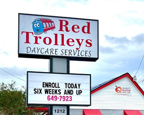 Sign outside Red Trolleys Daycare in Valdosta, GA, offering child care and preschool programs.