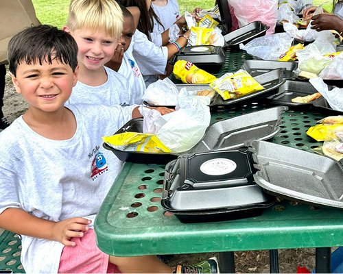 Children enjoying lunch at Red Trolleys Daycare in Valdosta, GA.
